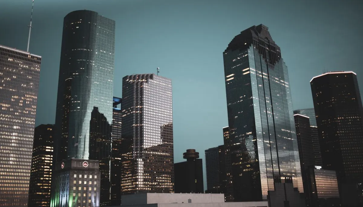 Low angle shot of tall buildings in the city during night time