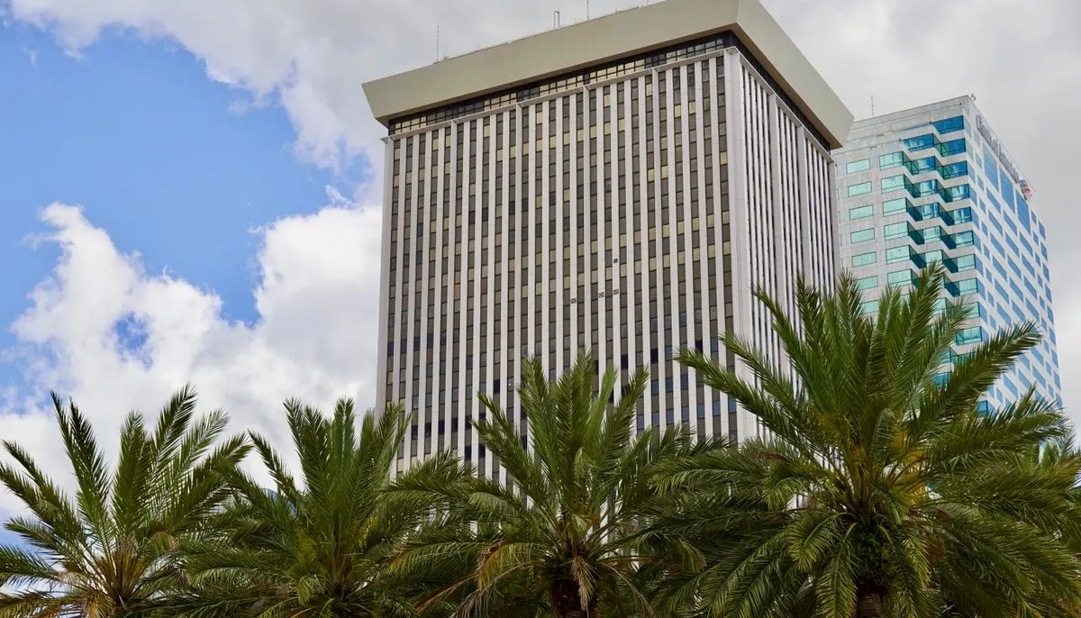 Palm trees near the glass buildings
