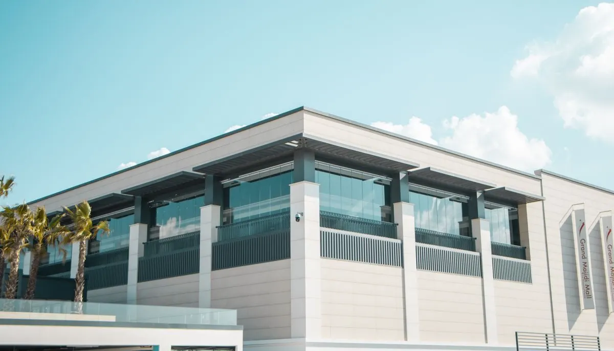 Exterior of a modern shopping mall under a blue sky