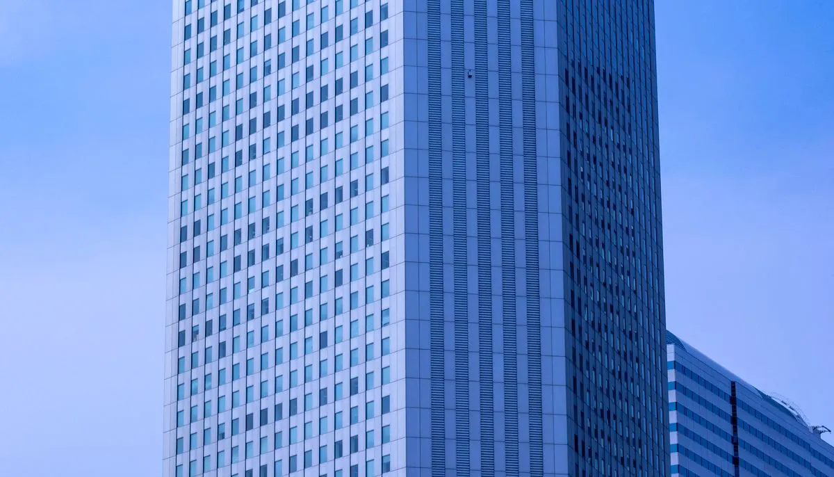 Modern glass skyscraper against blue sky