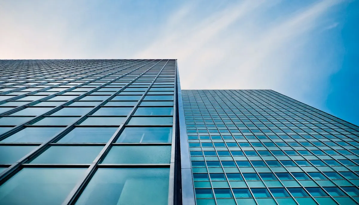Low angle view of office building against blue sky
