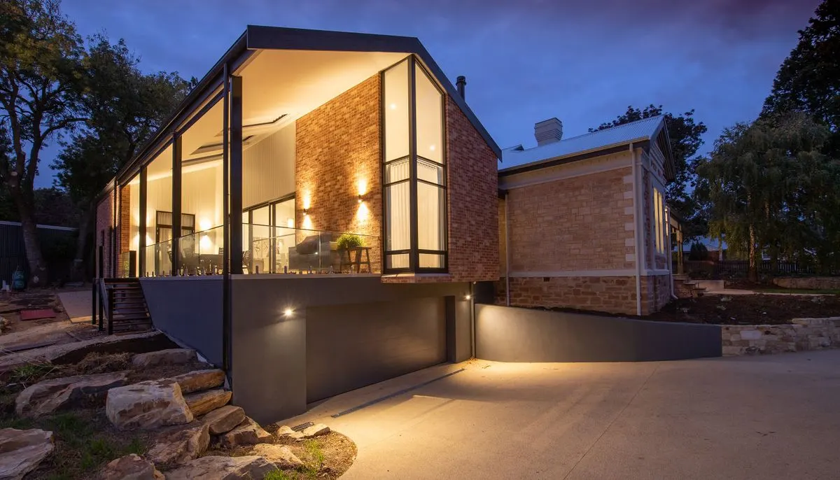 Modern house facade with glowing lights at dusk