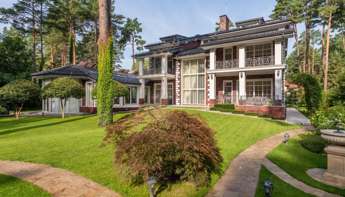 House near plants and trees on lawn