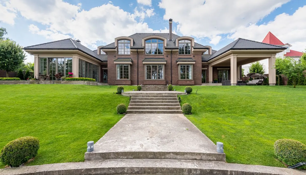 Frontage of an estate under a cloudy sky