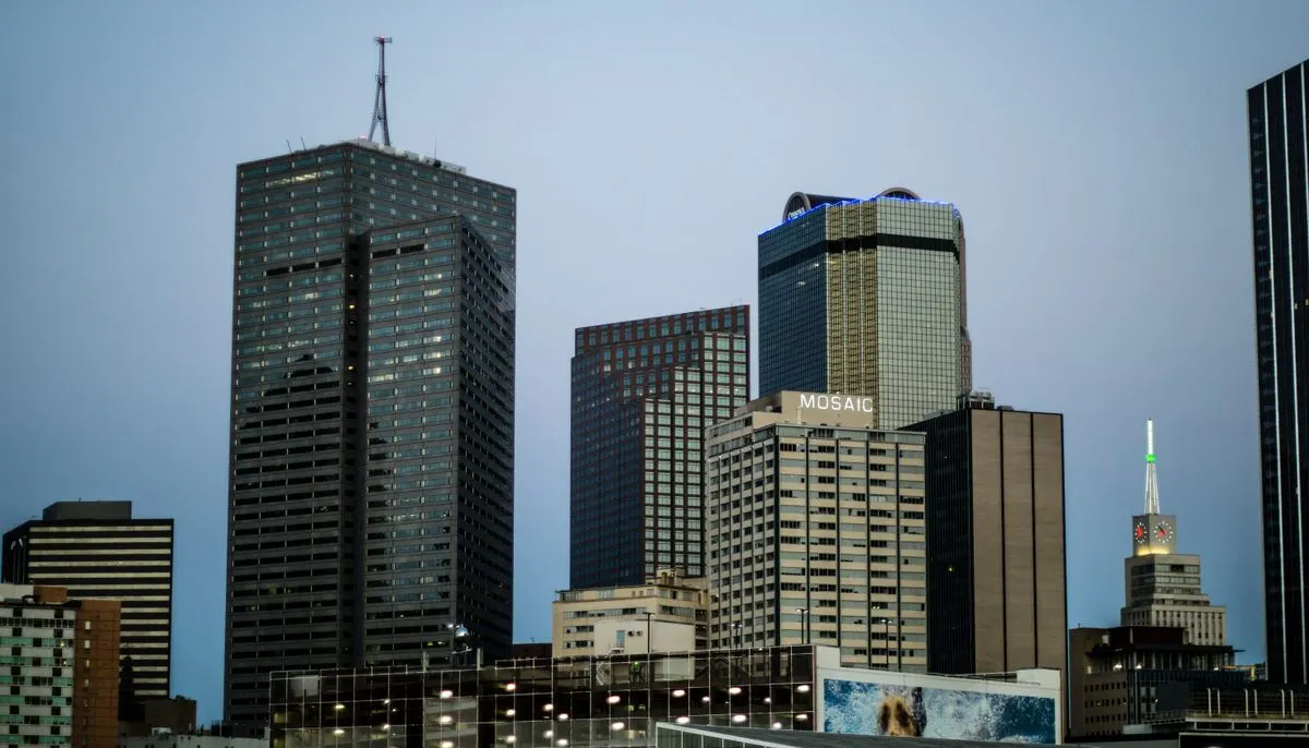 Black curtain glass building beside four curtain glass buildings under blue sky